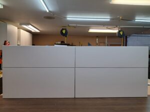 Alt=White bathroom vanity with sink and storage cabinets